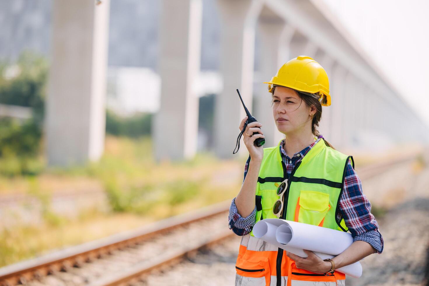 Engineer caucasian women railway tracks service team working on site survey check maintenance inspection train track for construction and safety photo