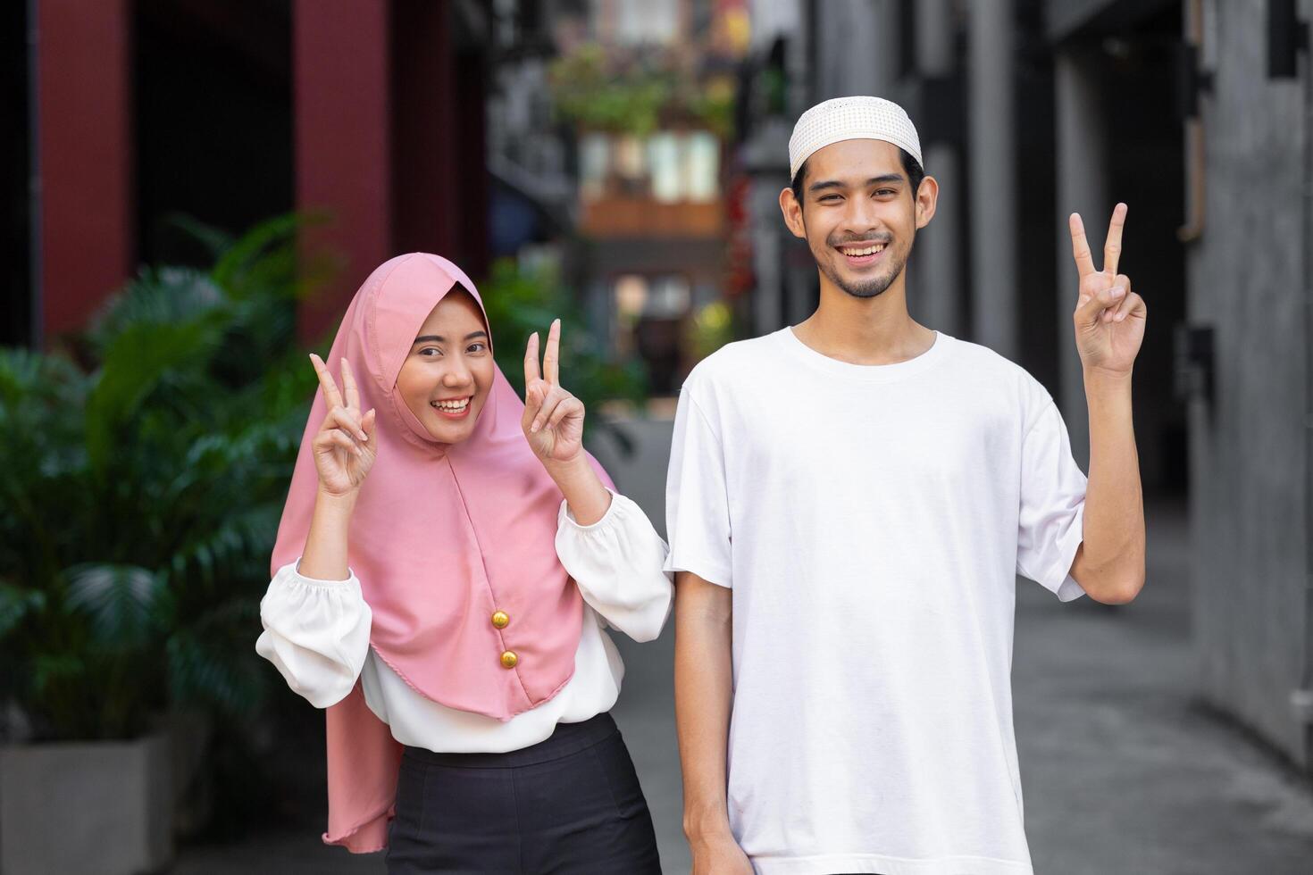 portrait happy muslim teen man and women couple lover friend standing together enjoy fun lifestyle outdoors photo