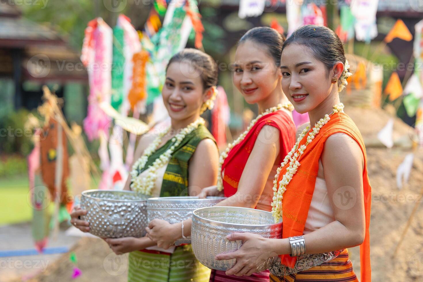 Songkran festival. Portrait Northern Thai people in Traditional clothes dressing handle handcrafted silver bowl in Songkran day summer Thailand cultural festival. photo