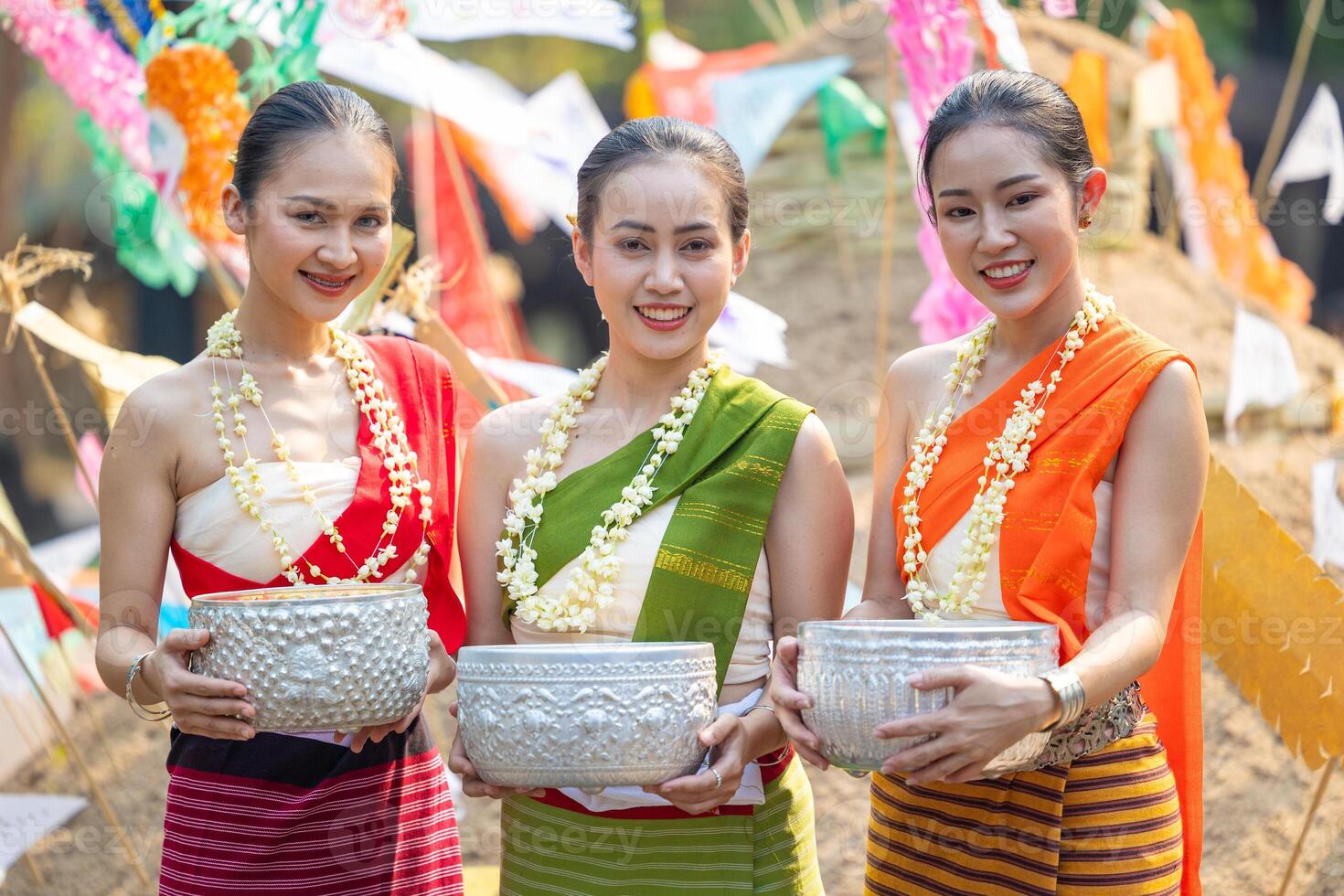 Songkran festival. Portrait Northern Thai people in Traditional clothes dressing handle handcrafted silver bowl in Songkran day summer Thailand cultural festival. photo