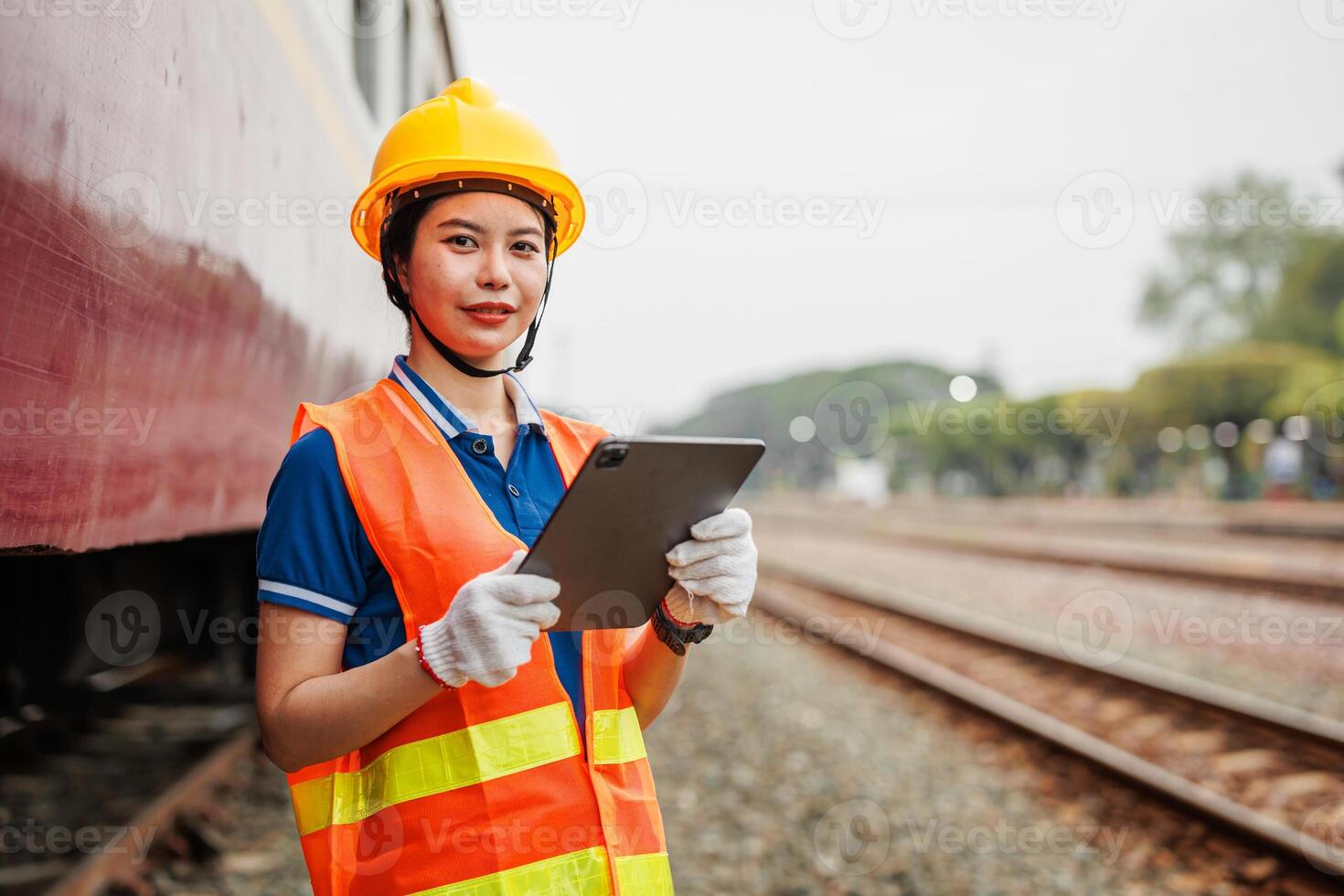 Train locomotive engineer women worker. Young teen Asian working check service maintenance train using tablet computer software. photo