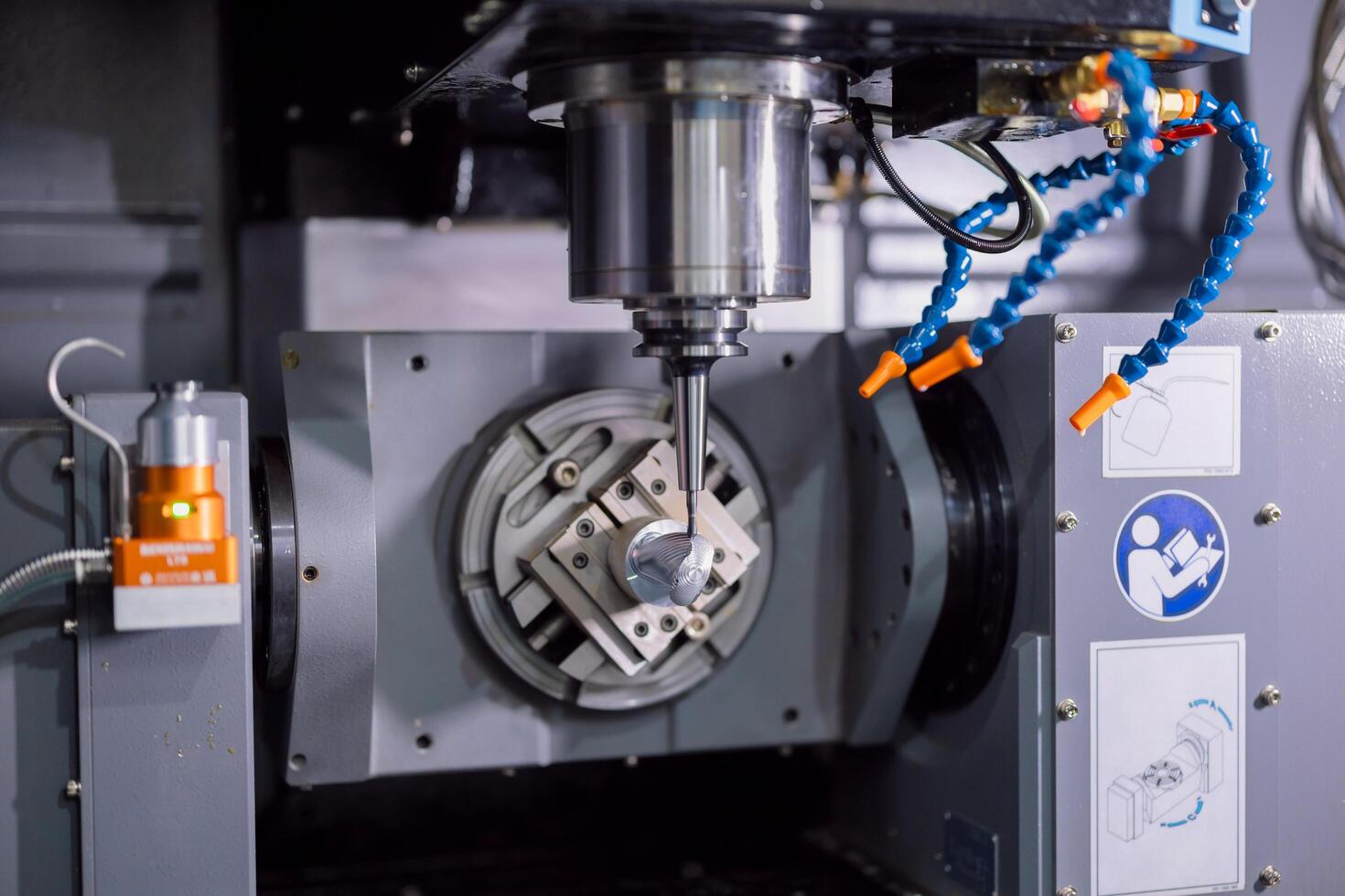 Modern 5 Axis CNC advance metal Milling Machine working in heavy industry factory. Drilling machine on working process in workshop photo