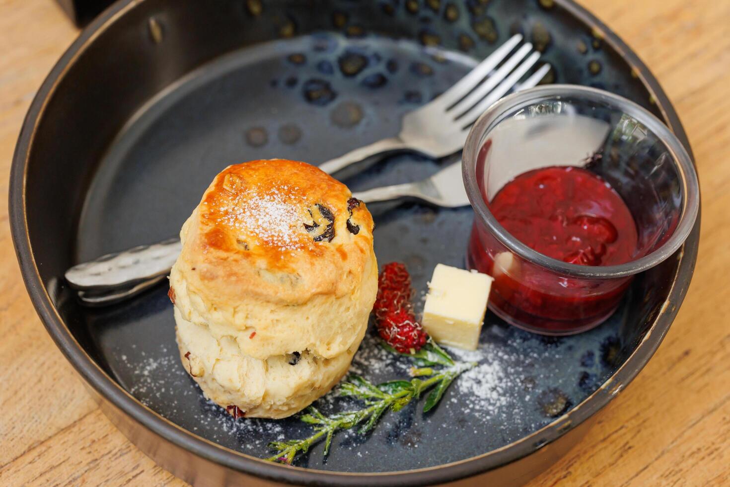 Scones with Strawberry Jam English style traditional quick bread menu served on wooden table photo