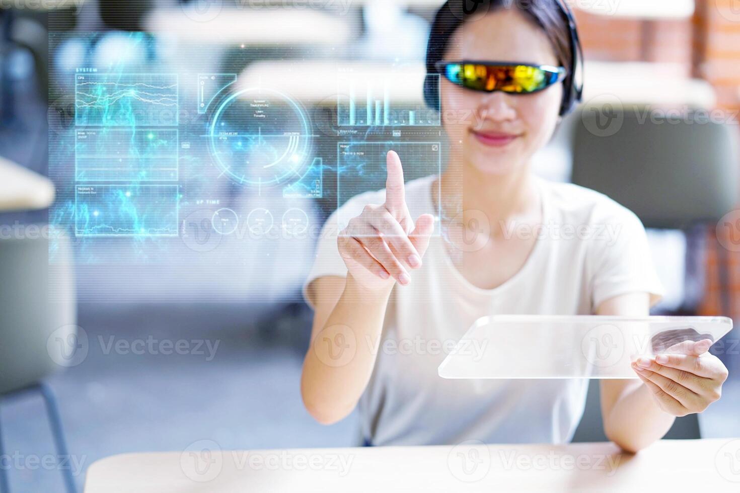 Closeup Asian female portrait holding and used transparence tablet computer working with lit by engineer HUD interface. GUI and Future technology concepts. photo