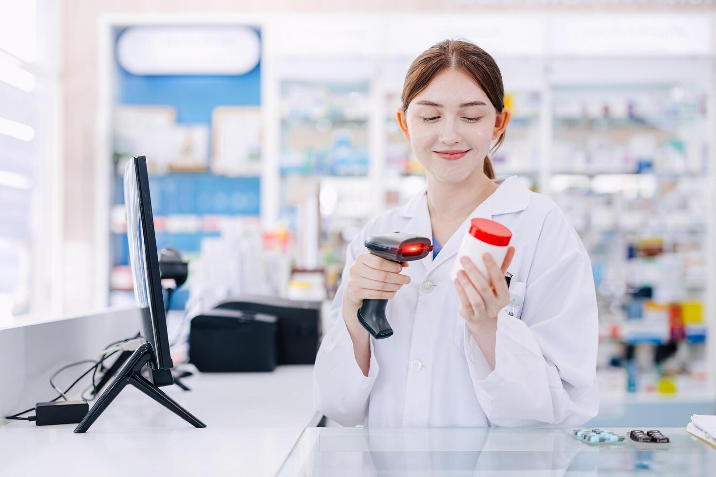 Pharmacist women at cashier medicine checkout, medical healthcare staff working in drugstore shop barcode scan for stock management control. photo