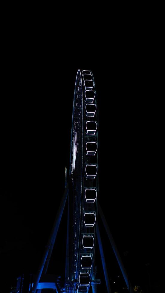 a ferris wheel at night photo