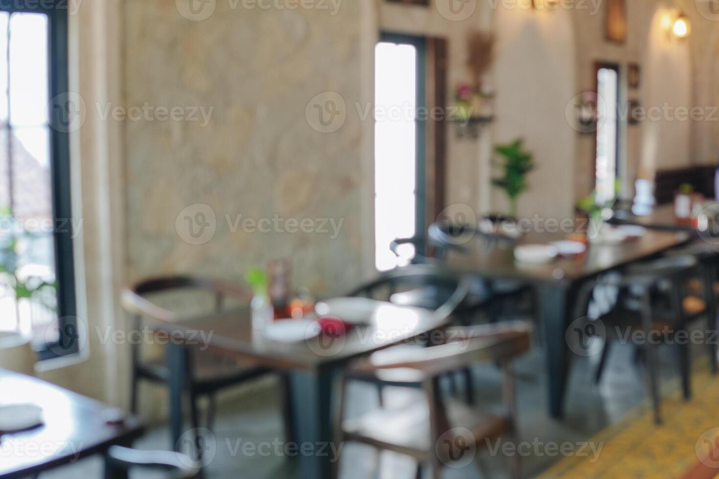 Interior portrait of a restaurant with a lot of tables and chairs. photo