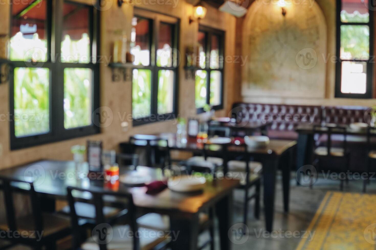 Interior portrait of a restaurant with a lot of tables and chairs. photo