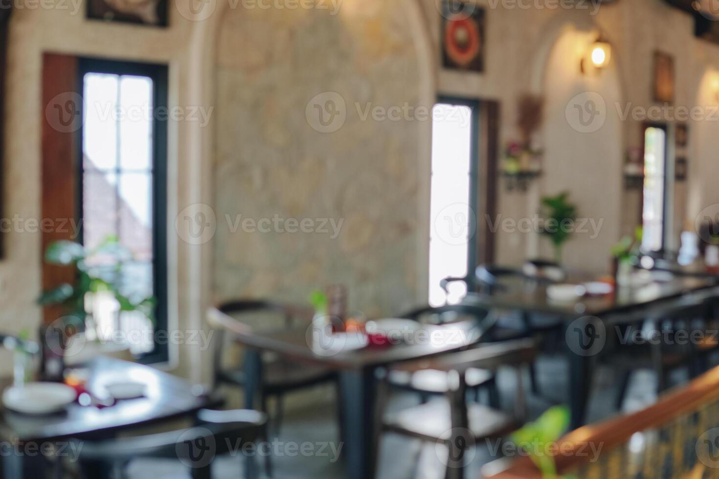 Interior portrait of a restaurant with a lot of tables and chairs. photo