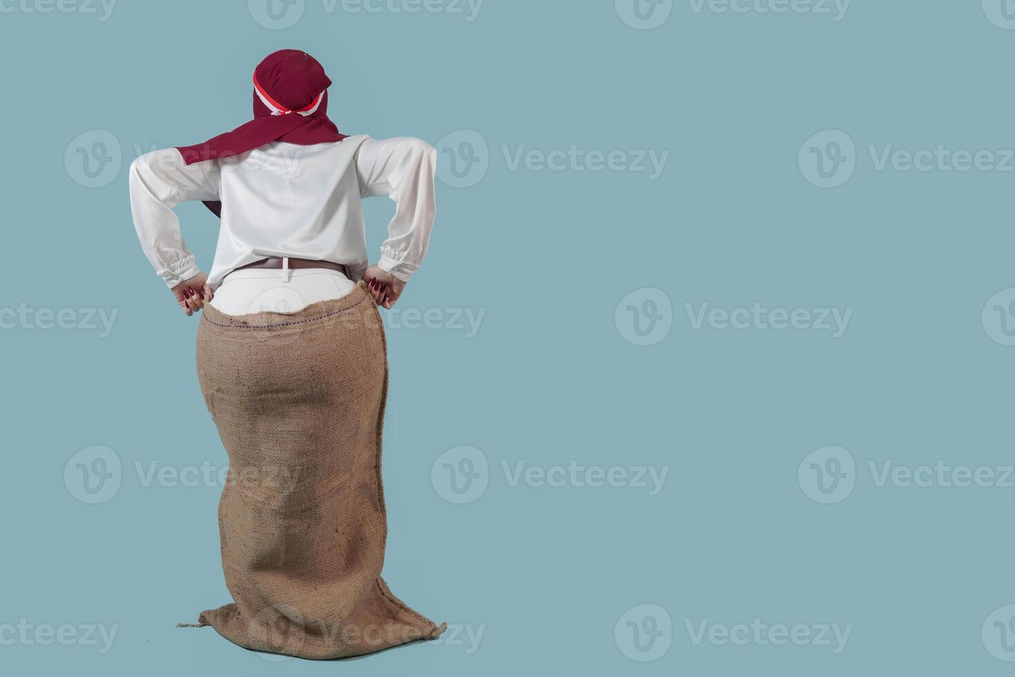 Indonesian woman wearing gunny sack to join competition Indonesian Independence Day celebration. photo