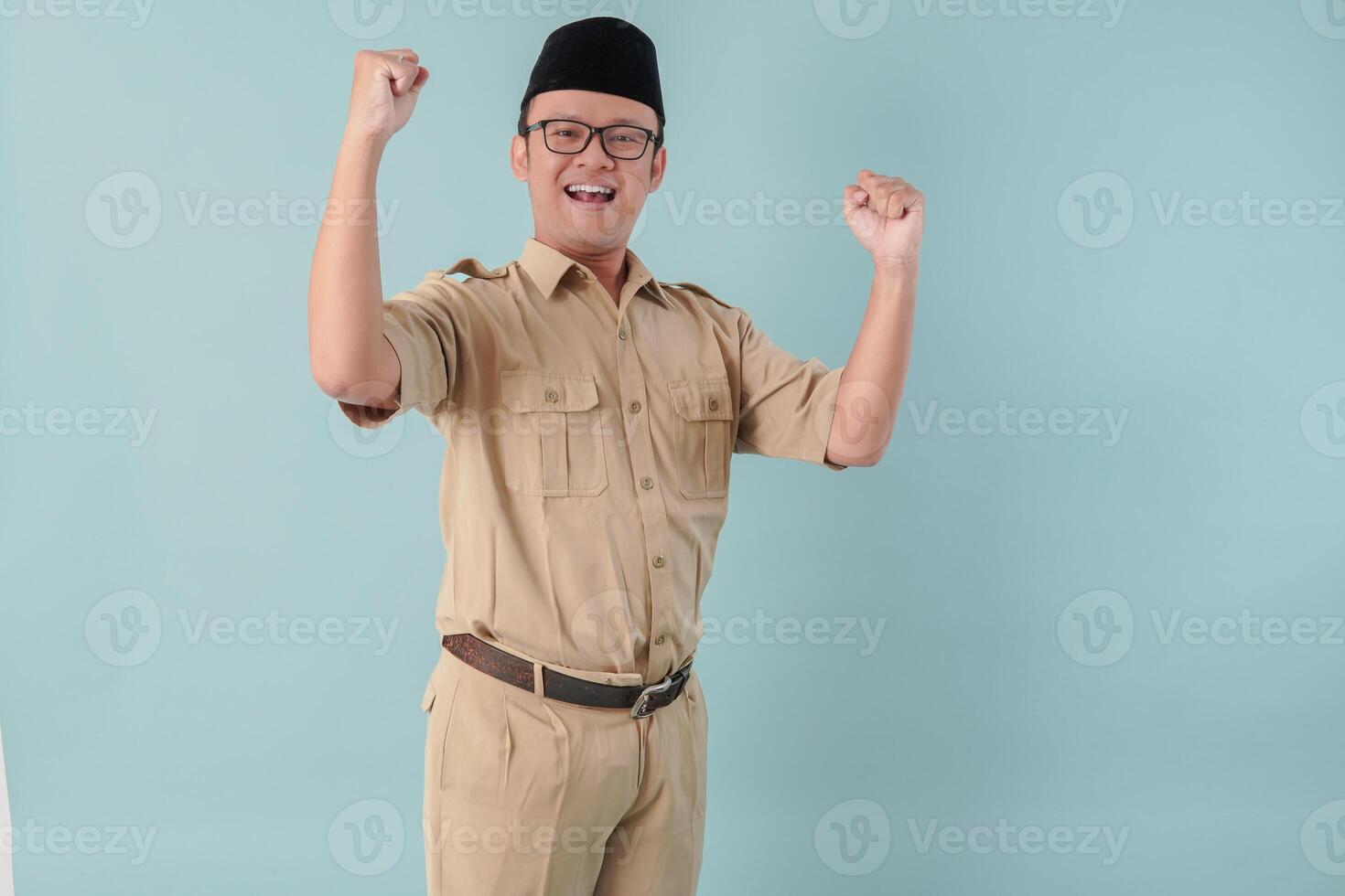 Excited Indonesian government worker man posing with a happy successful expression. photo