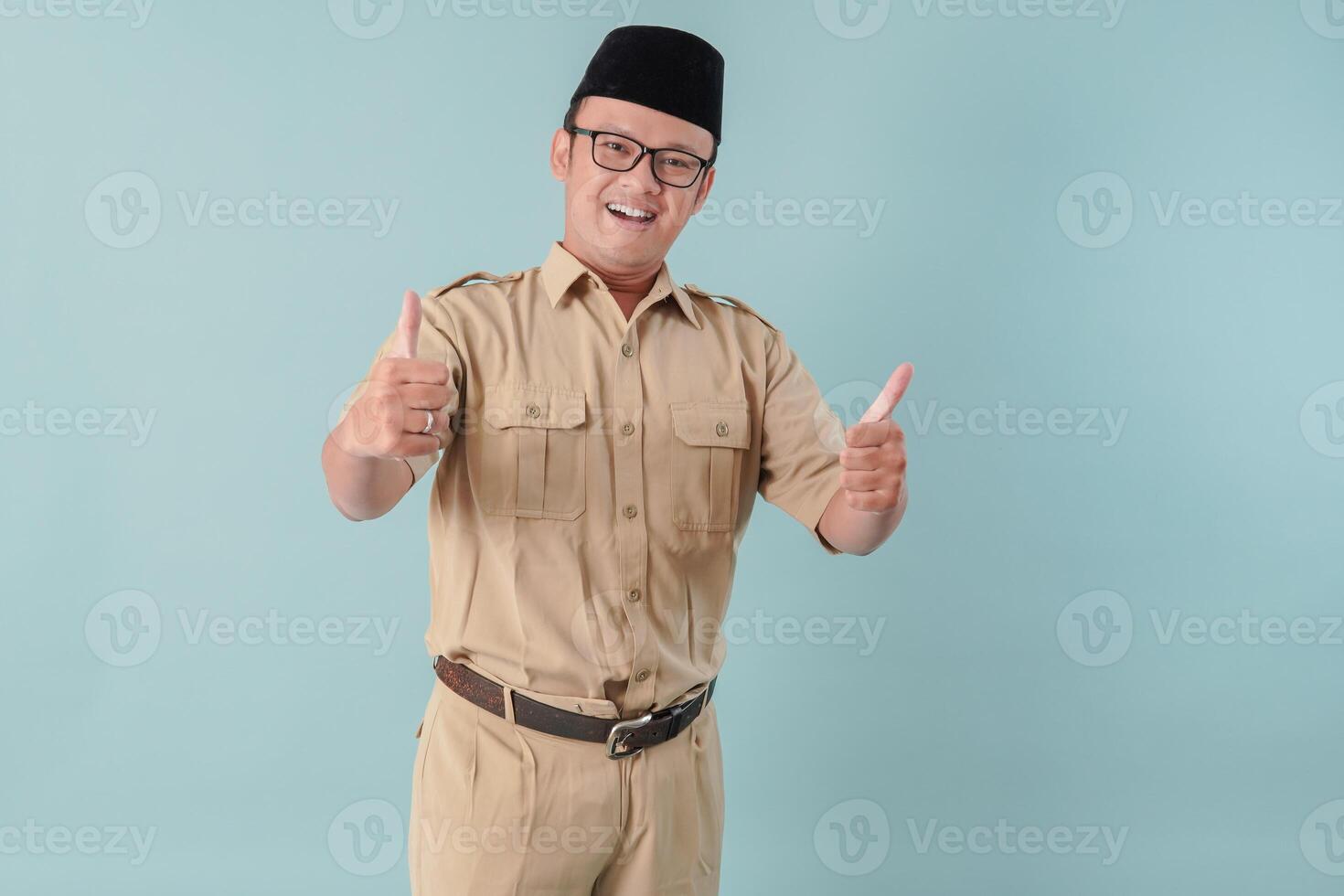 Handsome Indonesian government worker man smiling and giving thumb up gesture. photo