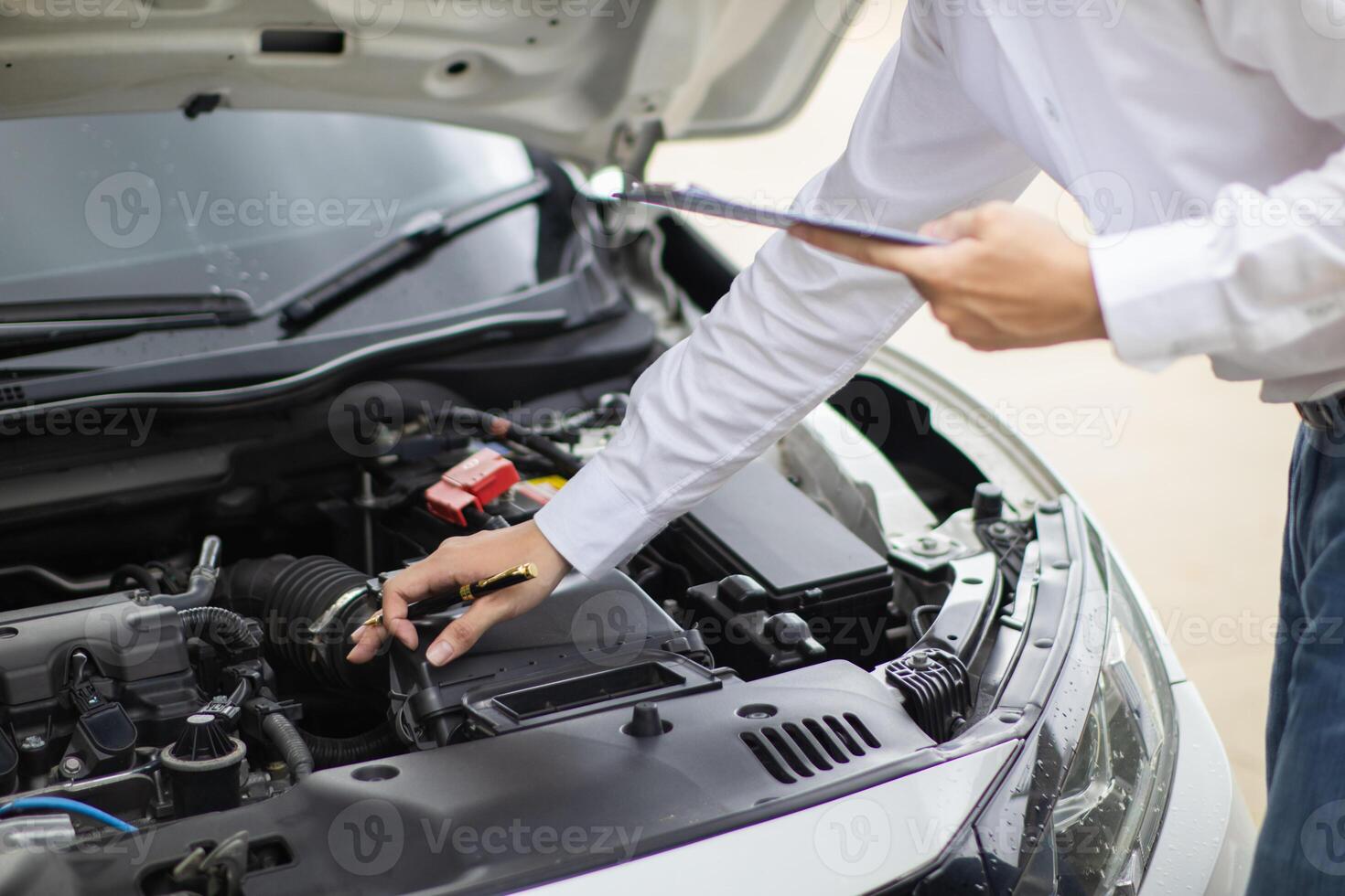 salesman is checking condition of car before delivering it to customer to ensure the quality and service after agreeing to sales contract. concept of checking the condition of the car for confidence photo