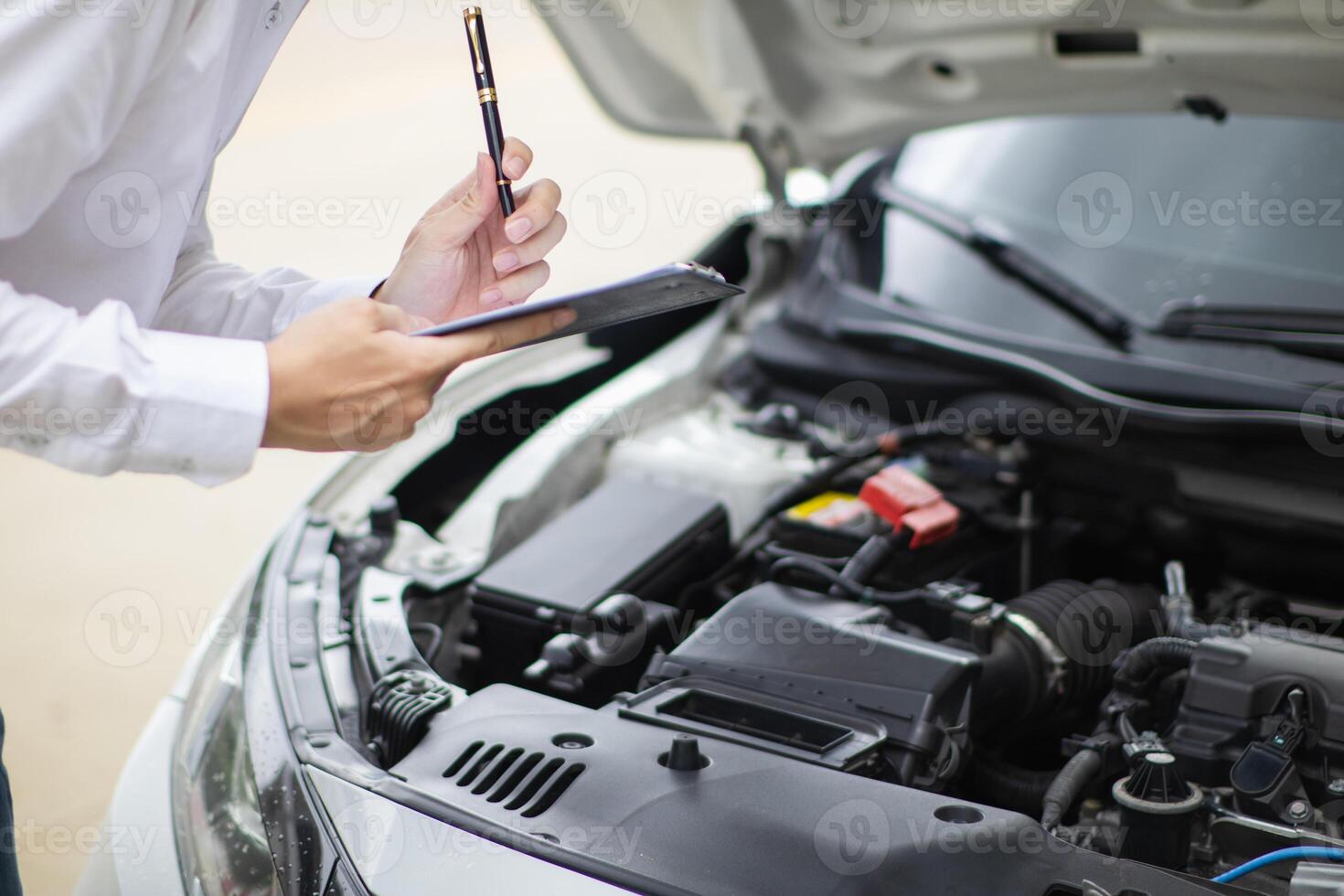 salesman is checking condition of car before delivering it to customer to ensure the quality and service after agreeing to sales contract. concept of checking the condition of the car for confidence photo