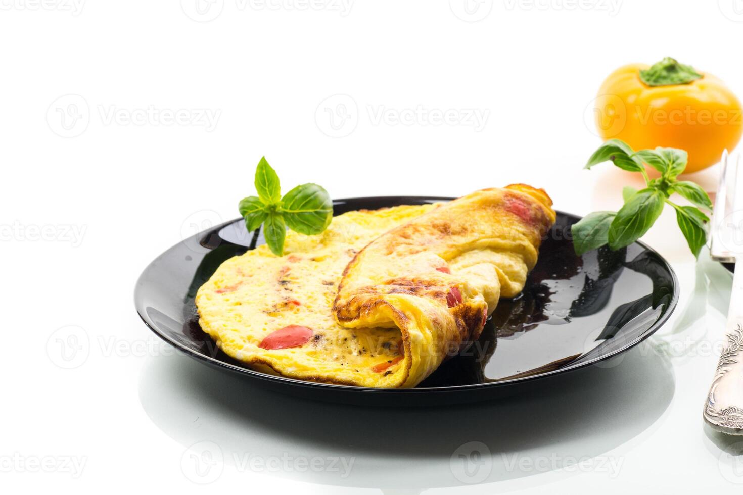 fried omelette with sweet pepper and vegetables in a plate, isolated on white background photo