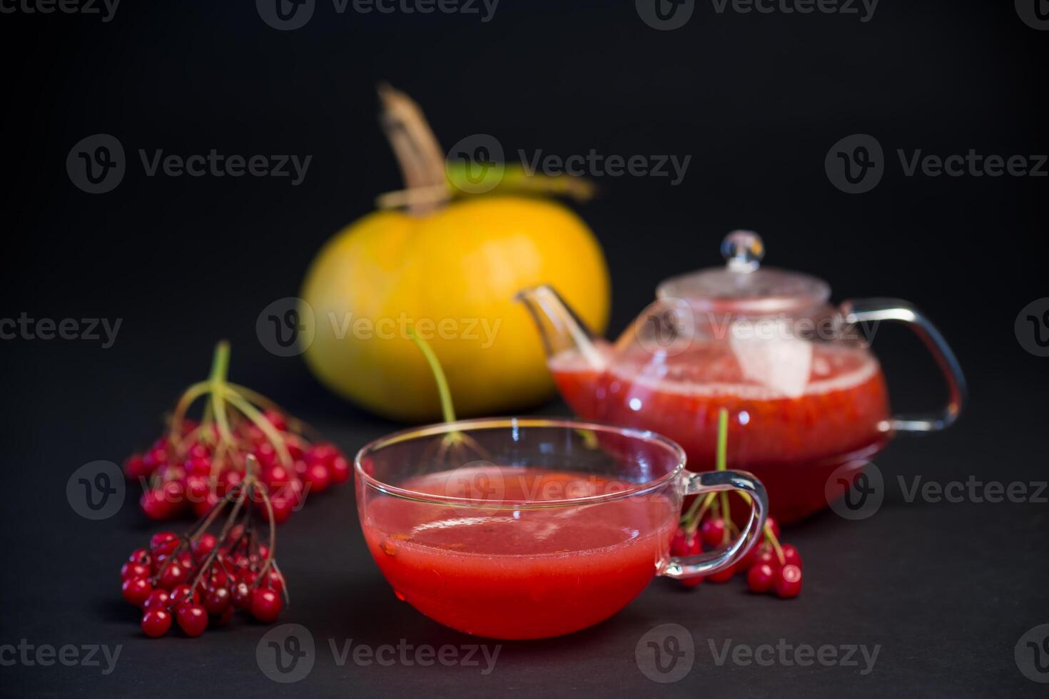 nutritious vitamin tea from viburnum berries, isolated on black background photo