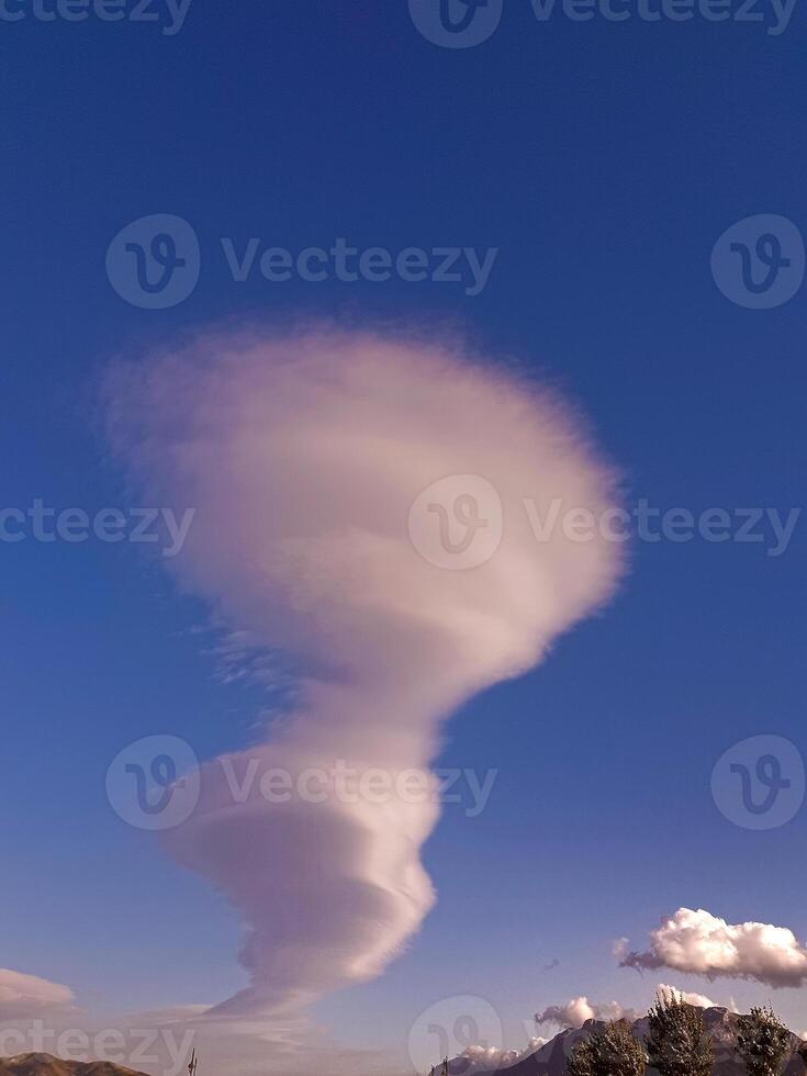 Mesmerizing cloud formation that appears to defy the tranquility of the clear sky photo
