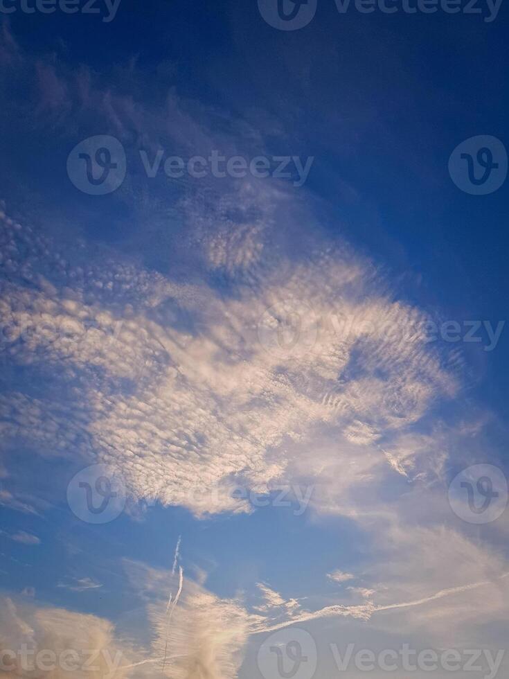 Vibrant cloudscape, where clouds in a fluffy formations, Sunshine reflects off the fluffy formations photo