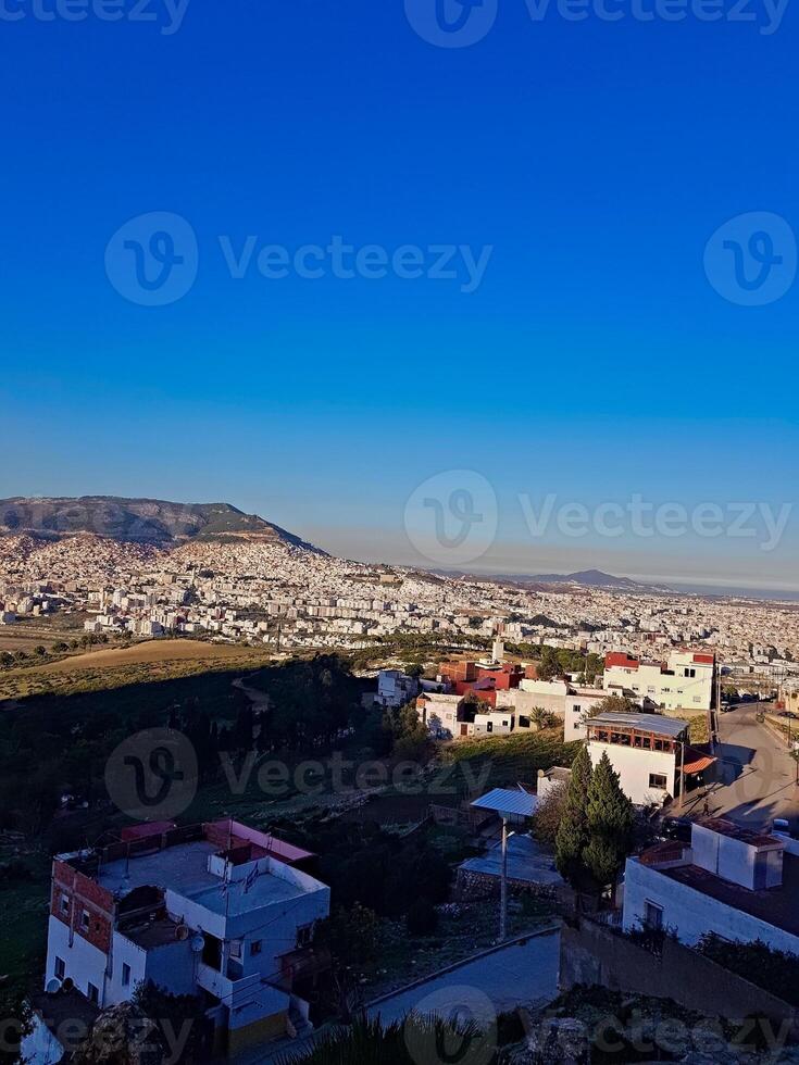 A view of the city from a distance and from the top during the charming evening hours before sunset photo