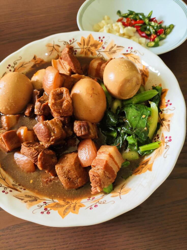 Braised pork belly with eggs and kale photo
