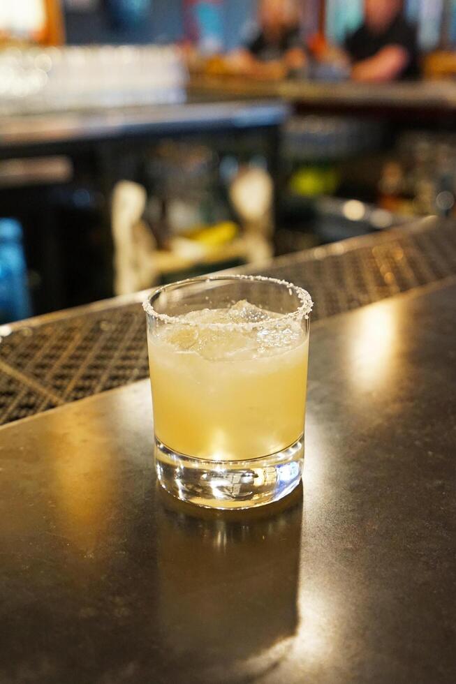 Close up Margarita- cocktail consisting of Tequila, orange liqueur and lime juice often served with salt on the rim of the glass photo