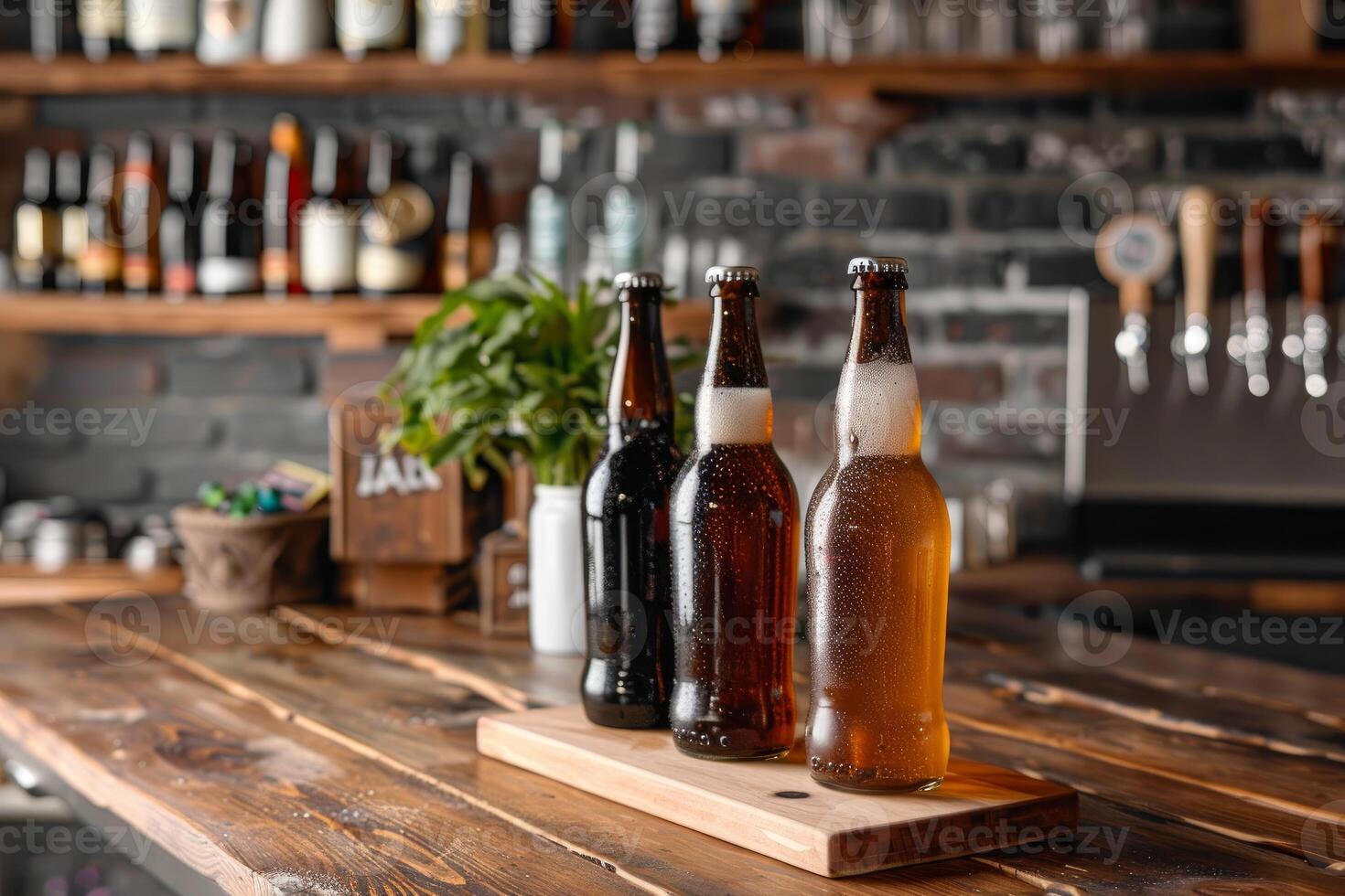 Three bottles of beer standing on wooden bar counter in pub photo