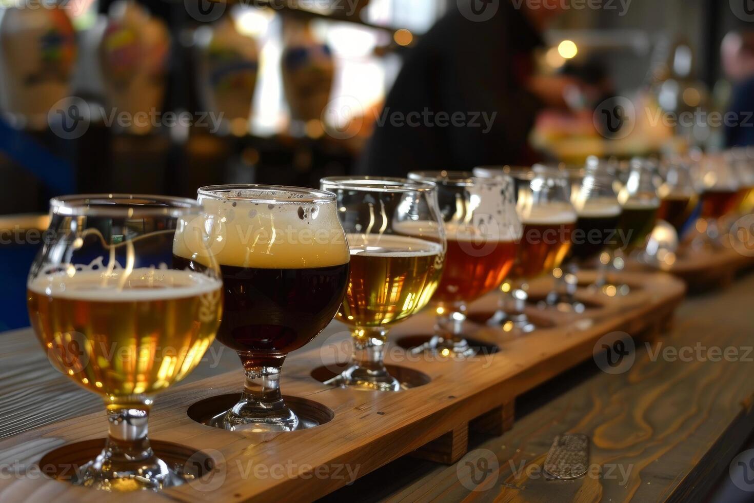 Eight different craft beers resting on bar top in brewery tasting room photo
