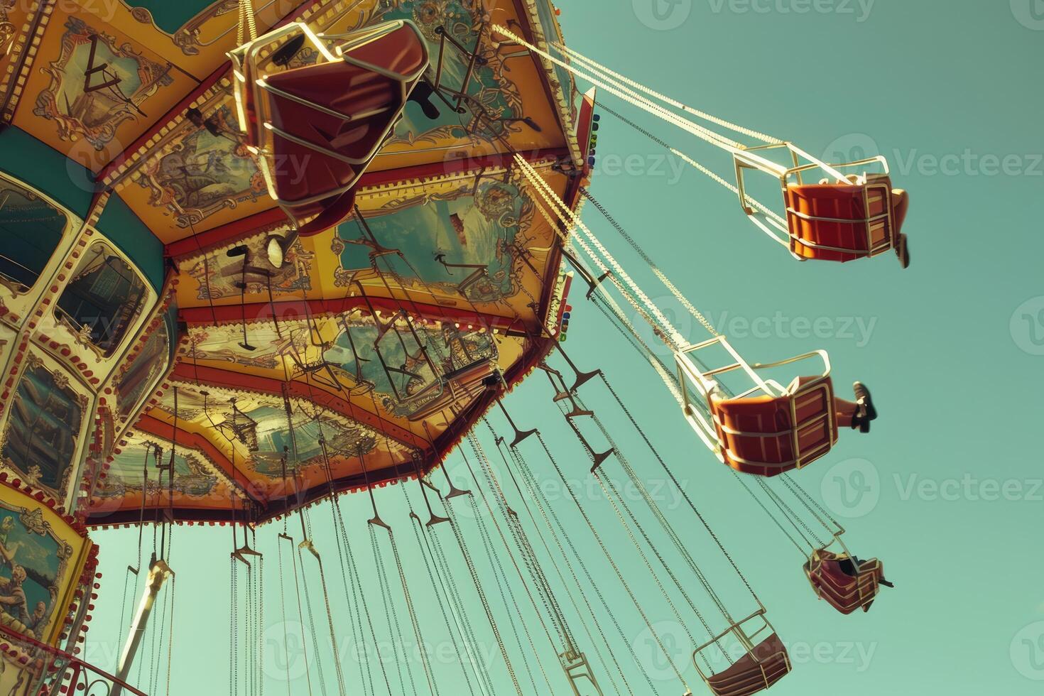 Vintage carnival ride swinging through a clear blue sky photo