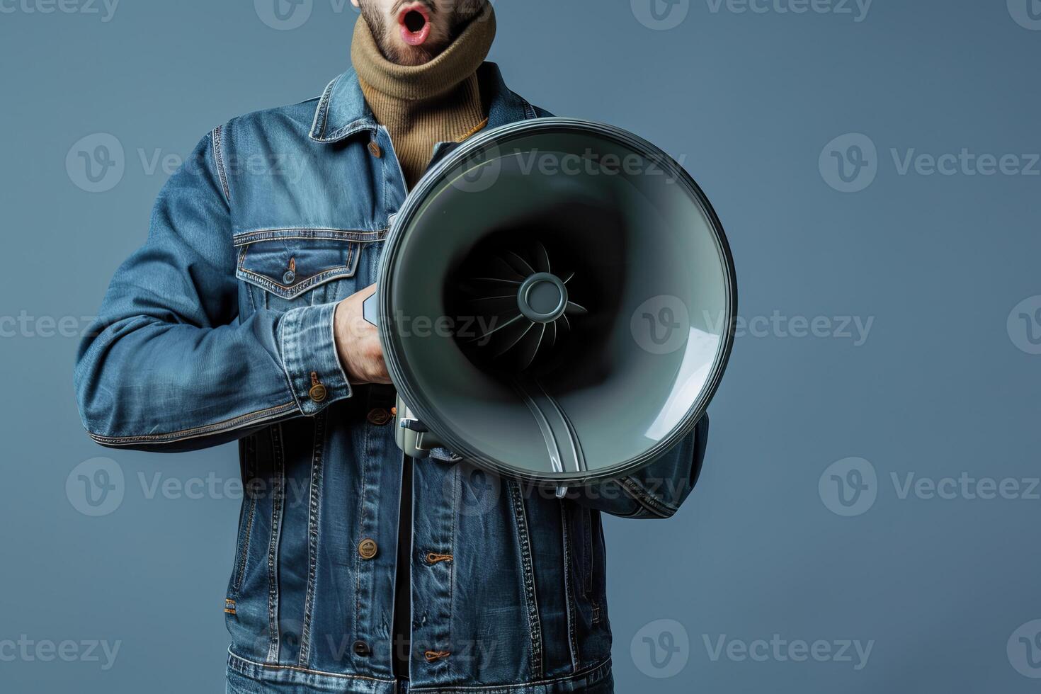 Man with open mouth holding megaphone making announcement photo