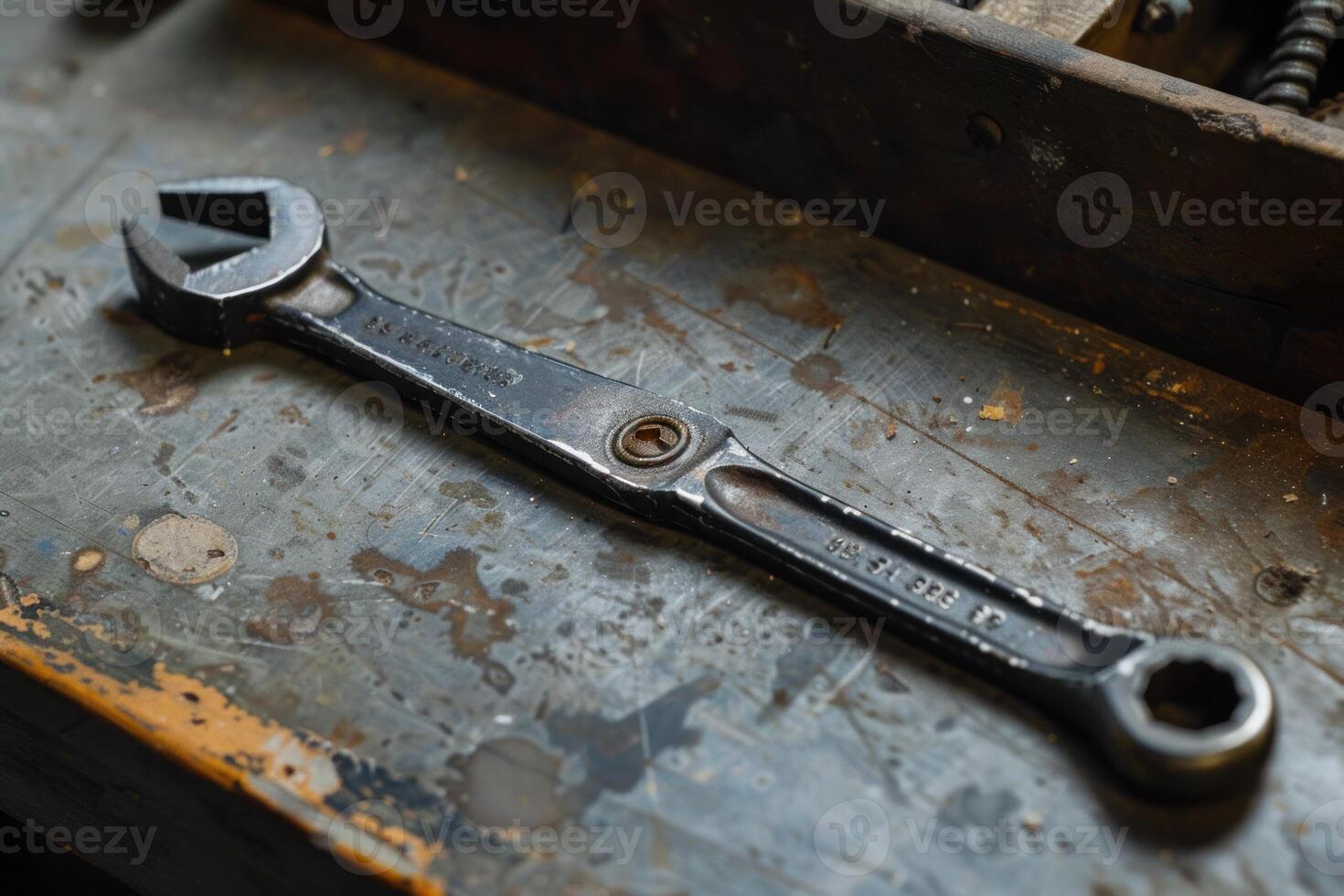 Adjustable wrench lying on workbench in workshop photo