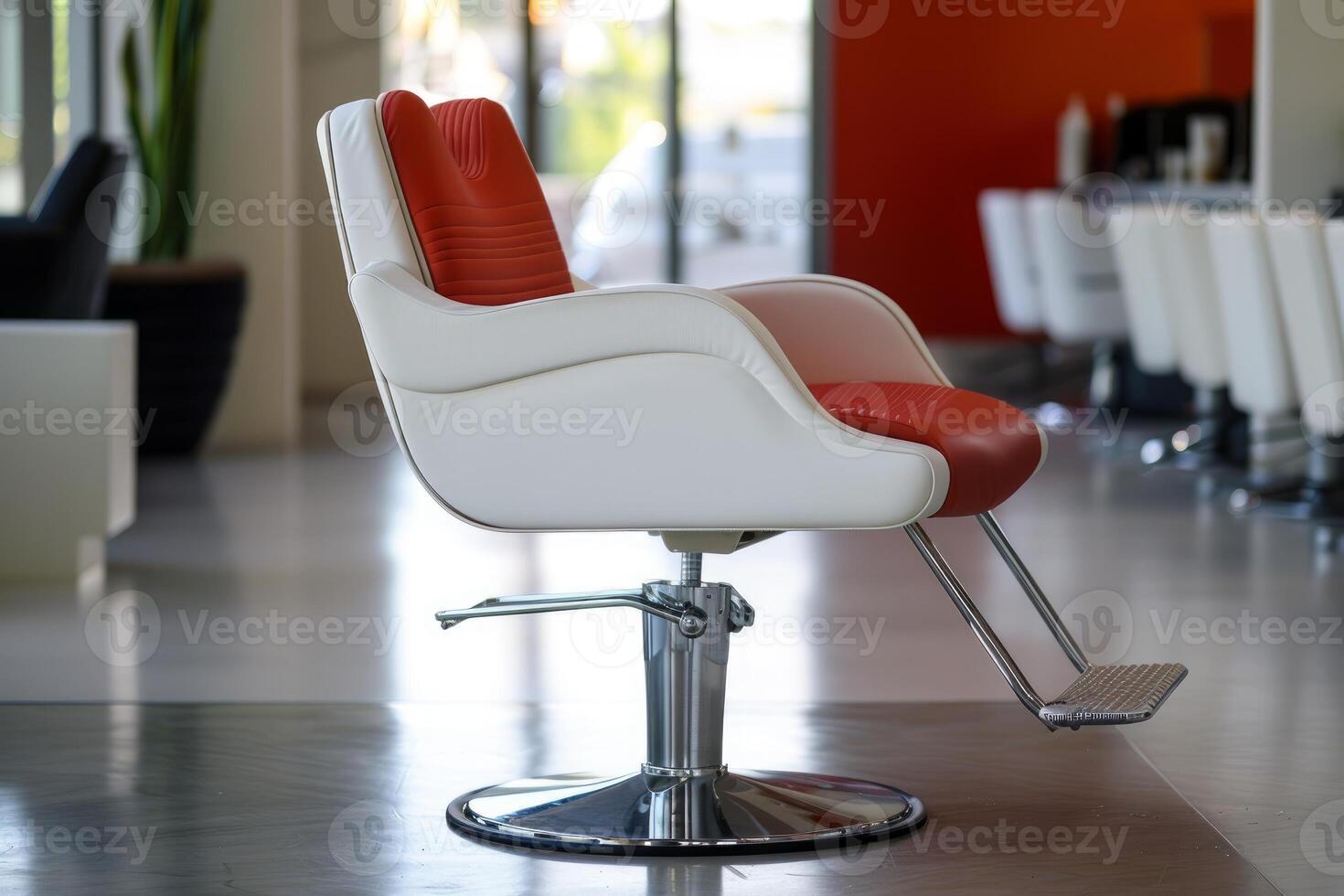 Modern red and white barber chair in empty salon interior photo