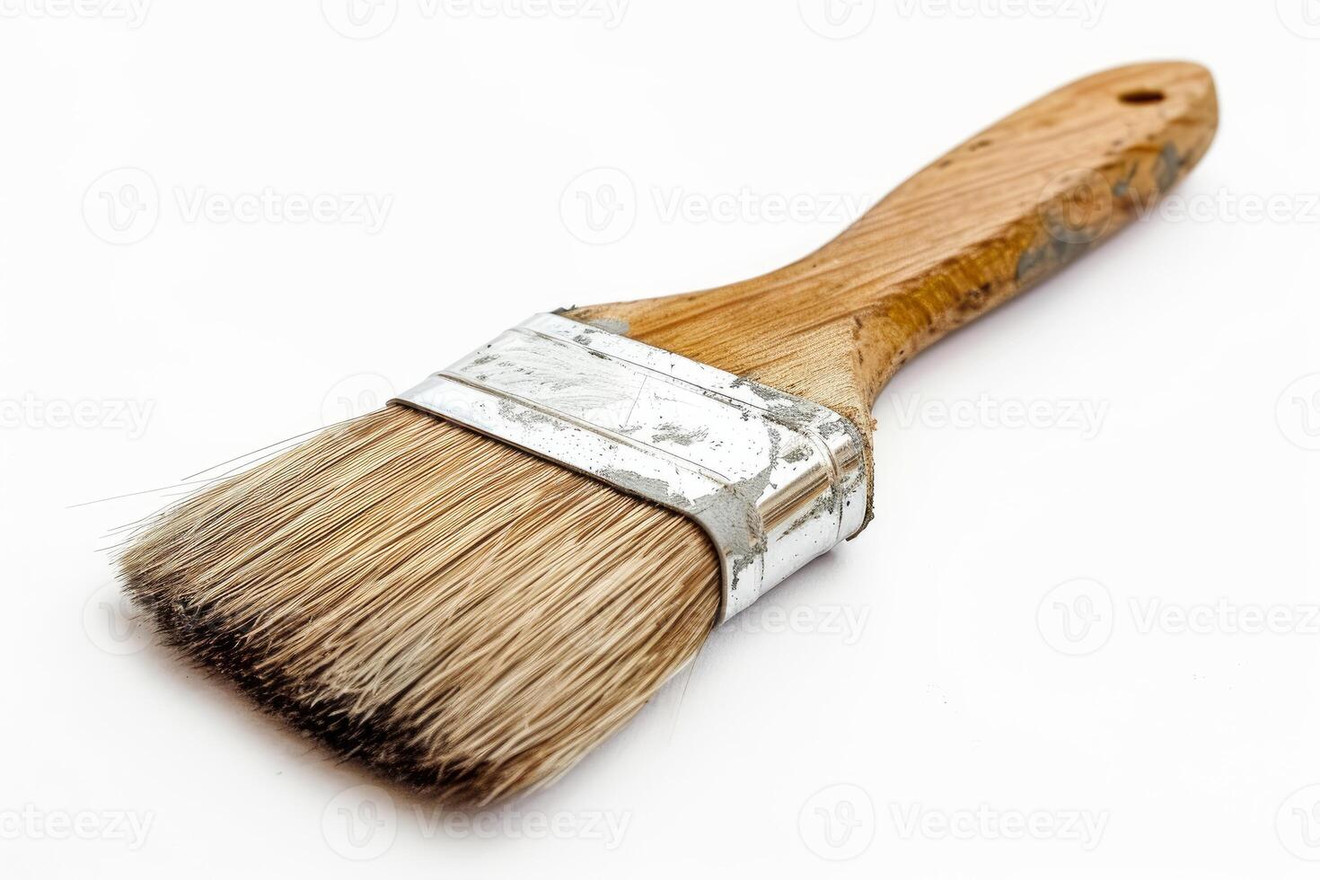 Used paint brush on a white background is lying on its side photo