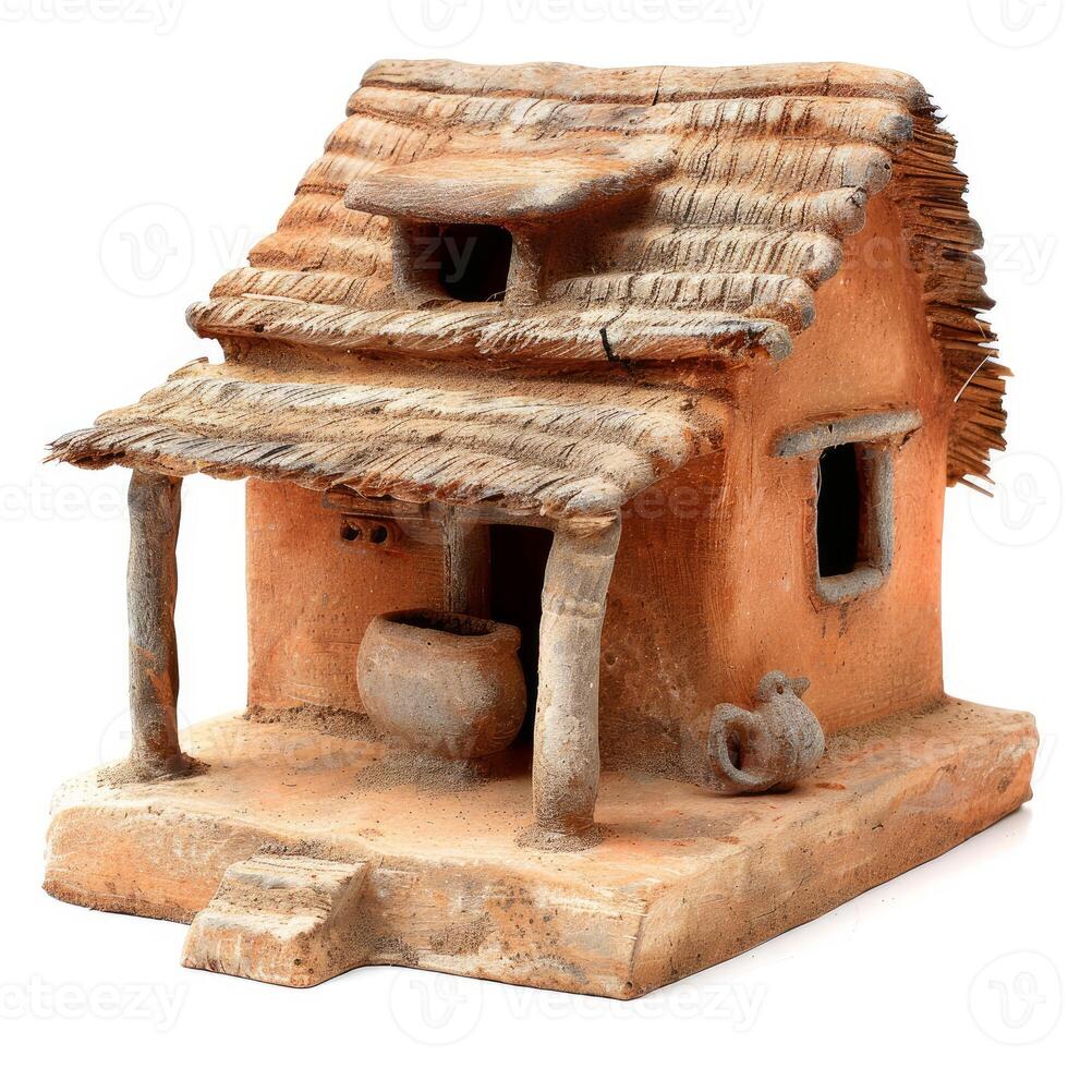 Clay model of a traditional hut with thatched roof displaying rural architecture photo