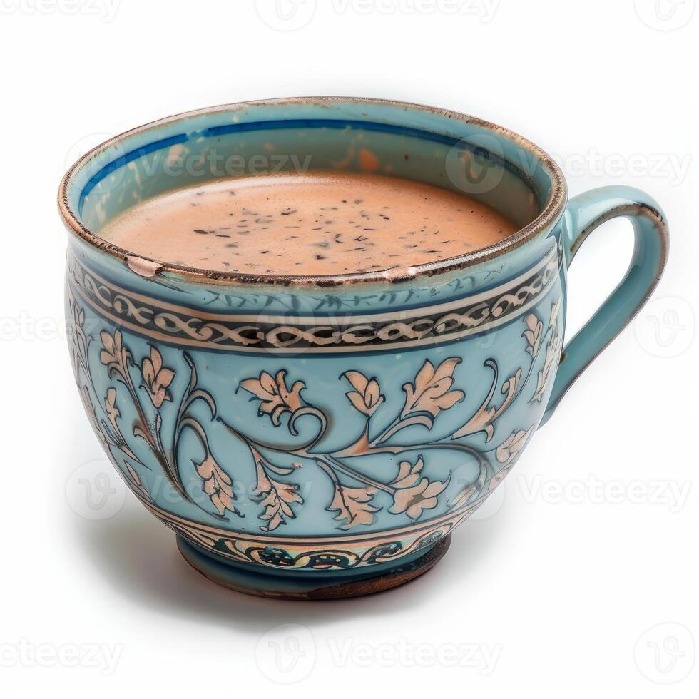 Steaming masala chai tea in traditional blue ceramic cup, isolated on white background photo