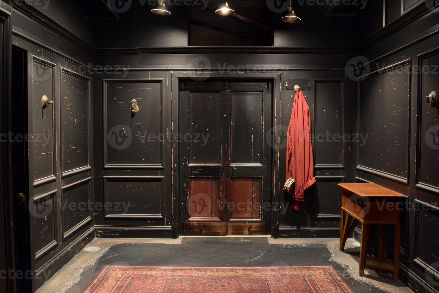 Old elevator with red jacket hanging in dark hallway photo
