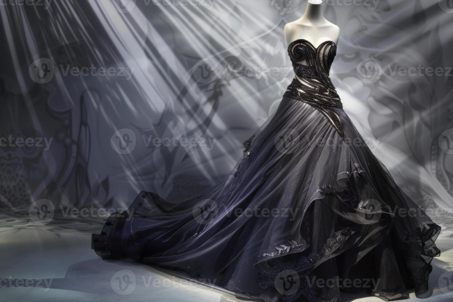Elegant dark gown displayed on mannequin in softly lit room photo