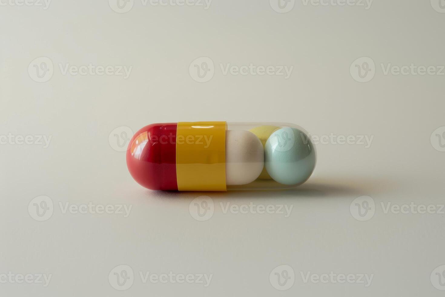 Red and yellow capsule pill containing colorful medical spheres photo