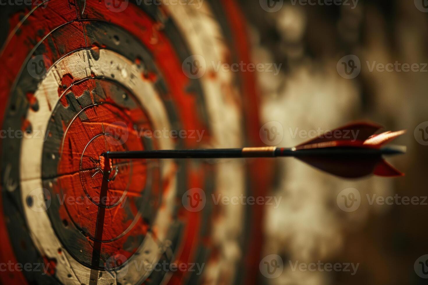 Arrow hitting the center of an old target on wood background photo