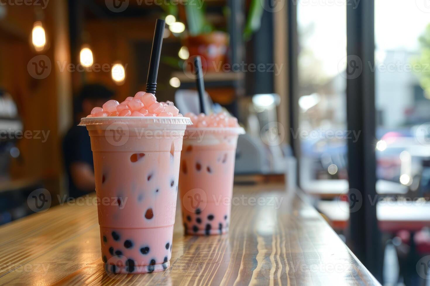 Two iced bubble tea drinks sitting on a cafe countertop photo