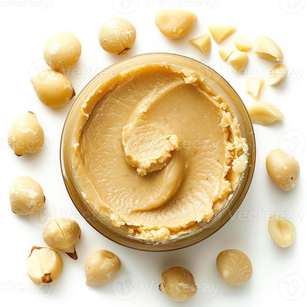 Macadamia nut butter surrounded by nuts and pieces on white background photo