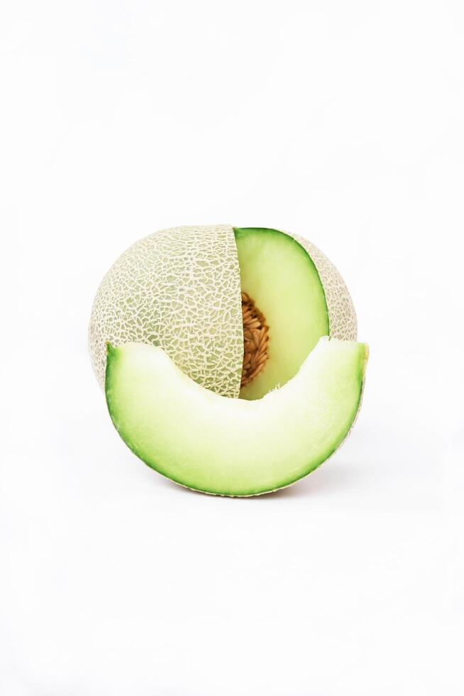 Green cantaloupe melon with cut slice isolated on white background, green melon photo