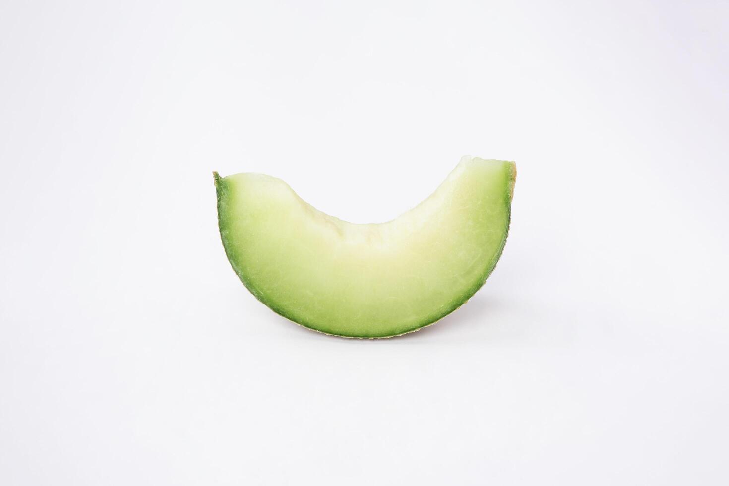 Green cantaloupe melon with cut slice isolated on white background, green melon photo