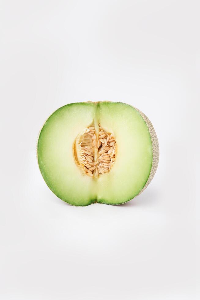 Green cantaloupe melon with cut slice isolated on white background, green melon photo