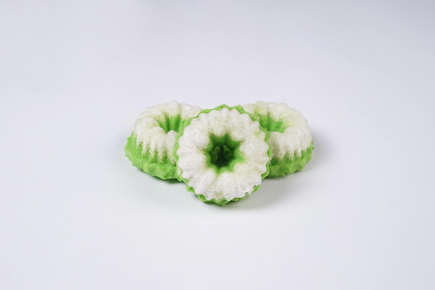 Putu ayu isolated on white background. It is a traditional dessert made from steamed rice flour and topped with grated coconut, a classic Indonesian cake photo