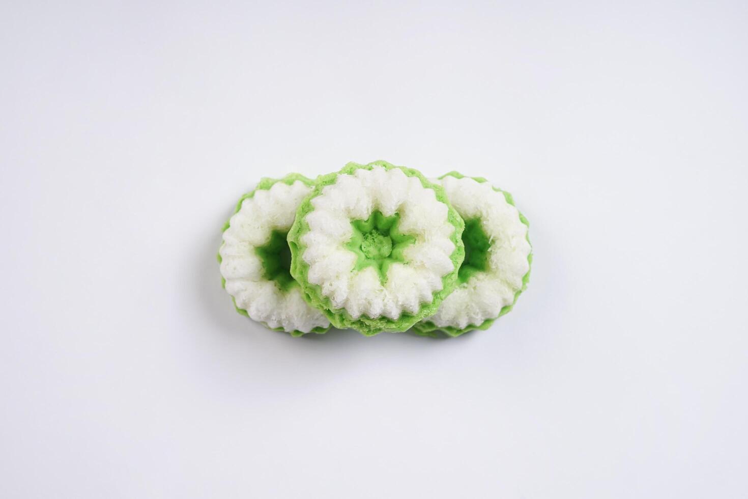 Putu ayu isolated on white background. It is a traditional dessert made from steamed rice flour and topped with grated coconut, a classic Indonesian cake photo