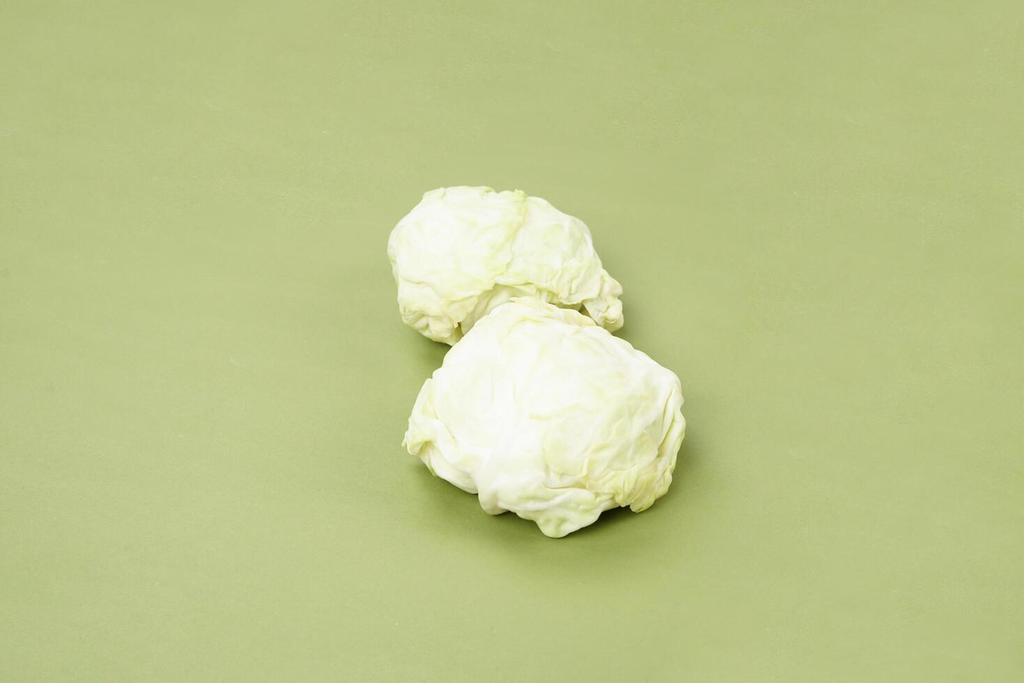 green cabbage isolated on a green background photo