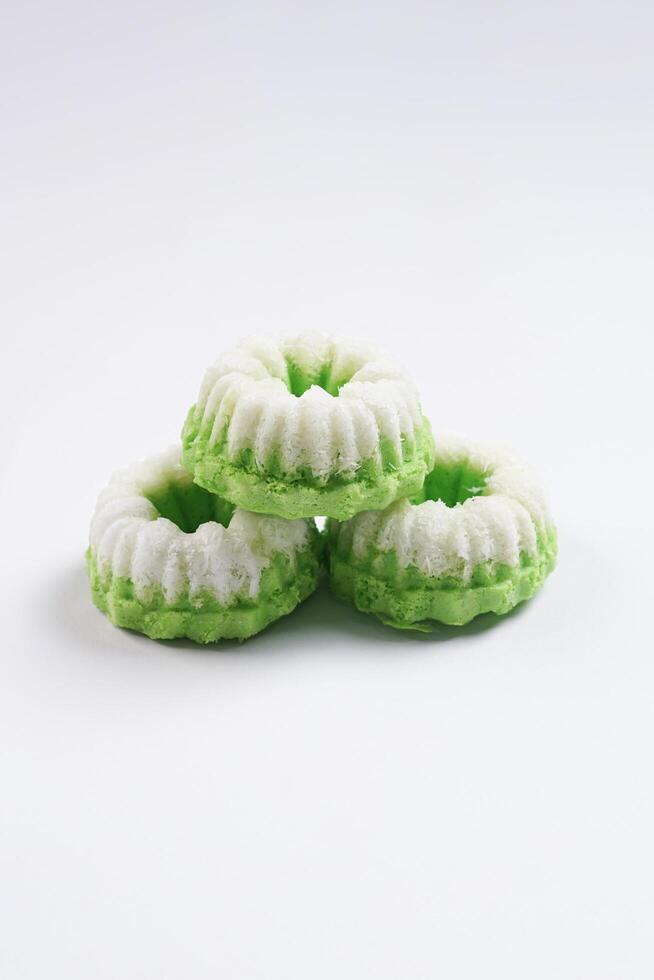Putu ayu isolated on white background. It is a traditional dessert made from steamed rice flour and topped with grated coconut, a classic Indonesian cake photo