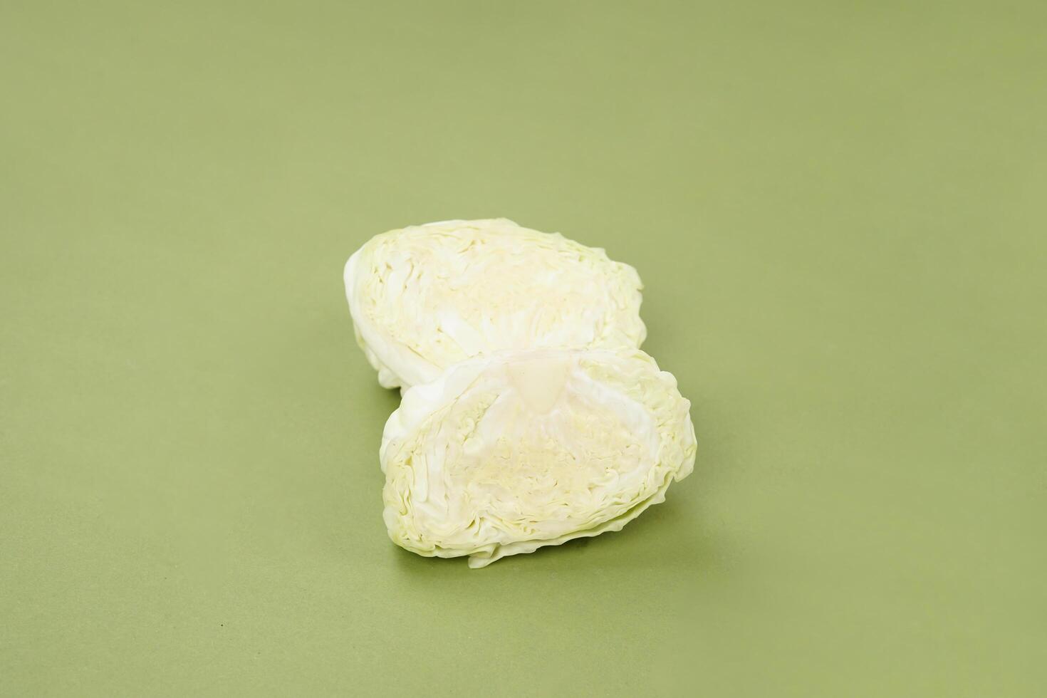 Fresh ripe cabbage vegetable isolated on a green background photo