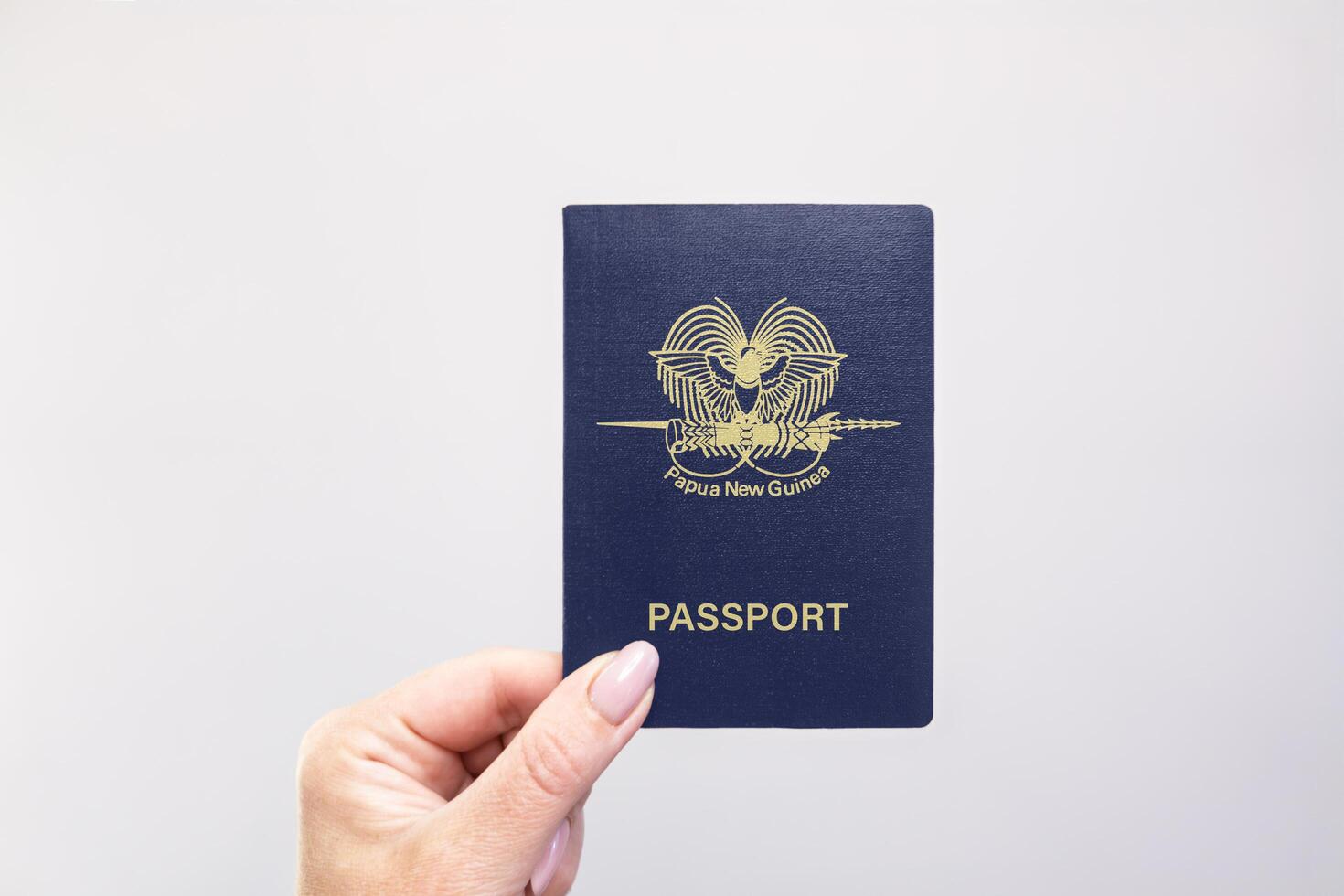 Passport Papua New Guinea Held Against Simple White Background. Astana, Kazakhstan, 26 october 2024 photo
