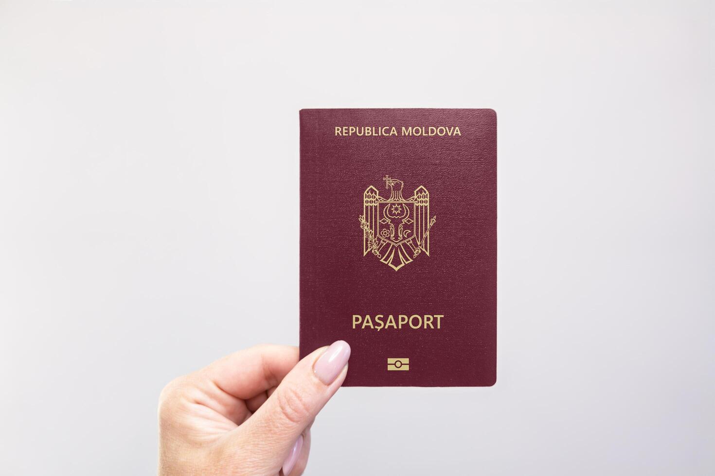 Moldova Passport Held Against Simple White Background. Astana, Kazakhstan, 26 october 2024 photo